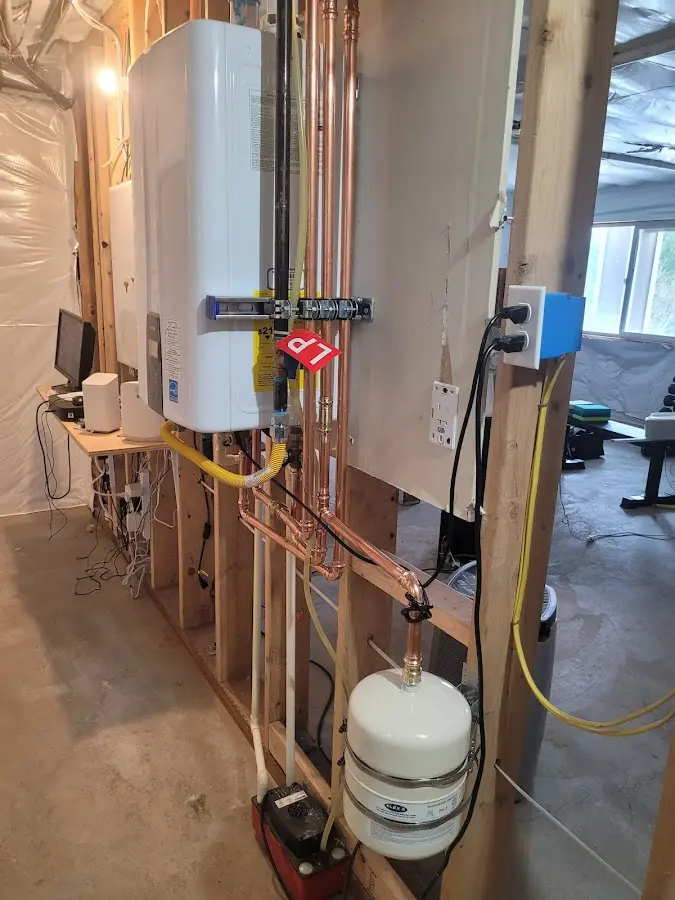 Licensed plumber repairing a kitchen sink in Newton